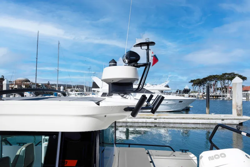 Slide: The Image of 2022 Axopar 28 CABIN at a marina with other boats. - 22