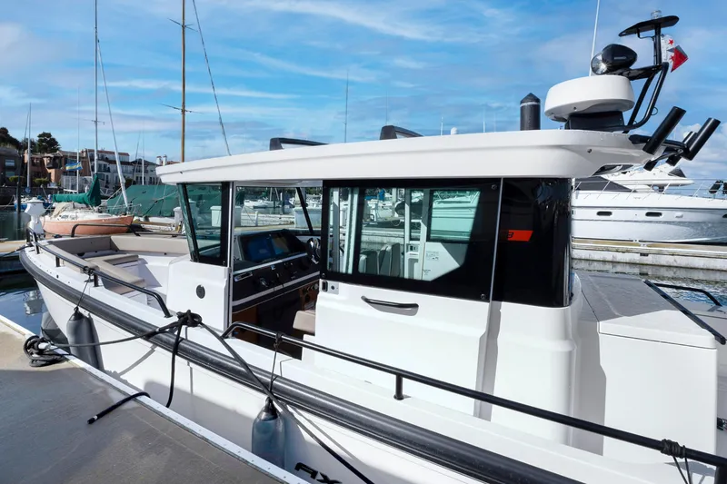 Slide: The Image of 2022 Axopar 28 CABIN boat docked at marina. - 24