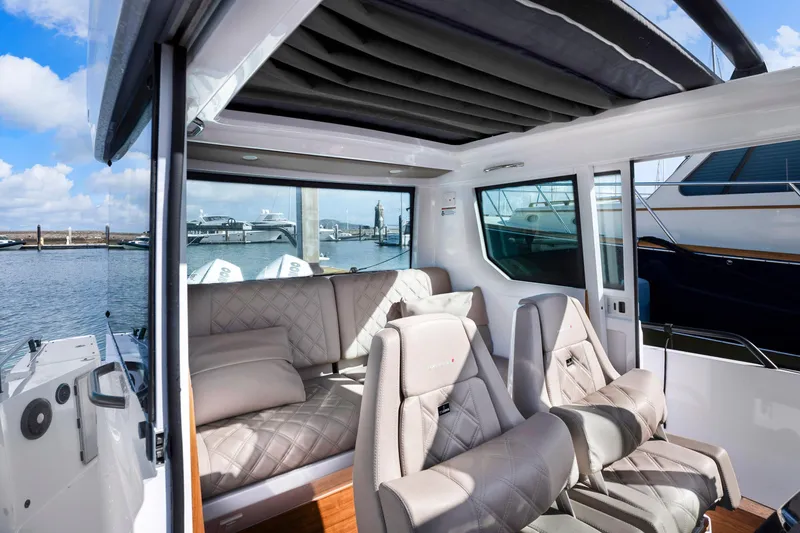 Slide: The Image of Interior of 2022 Axopar 28 CABIN boat with luxurious seating and waterfront view. - 25