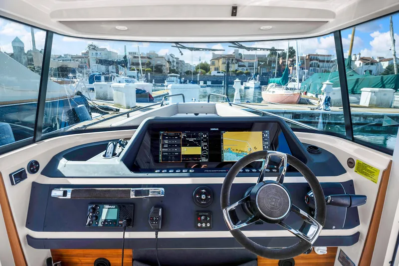 Slide: The Image of Modern helm station of 2022 Axopar 28 CABIN boat with advanced navigation system. - 8