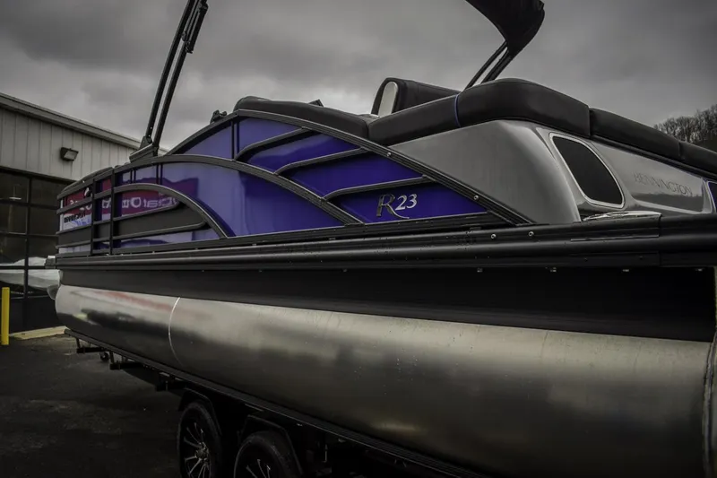 Slide: The Image of 2024 Bennington 23 RSBSR pontoon boat with sleek design and purple accents. - 2