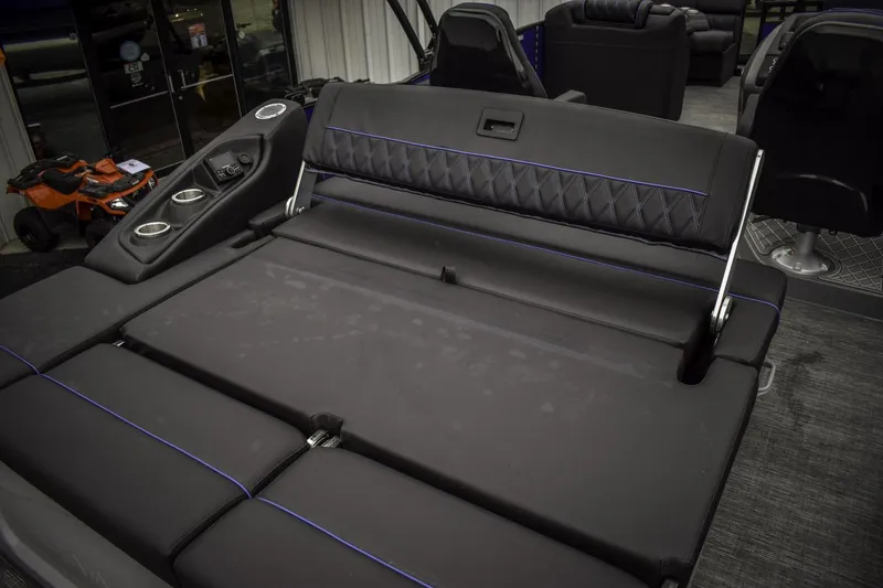 Slide: The Image of 2024 Bennington 23 RSBSR boat interior with luxurious black seating and blue accents. - 4