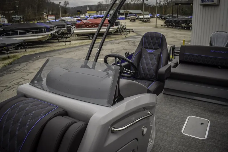 Slide: The Image of 2024 Bennington 23 RSBSR pontoon boat interior with captain's chair and helm station. - 8