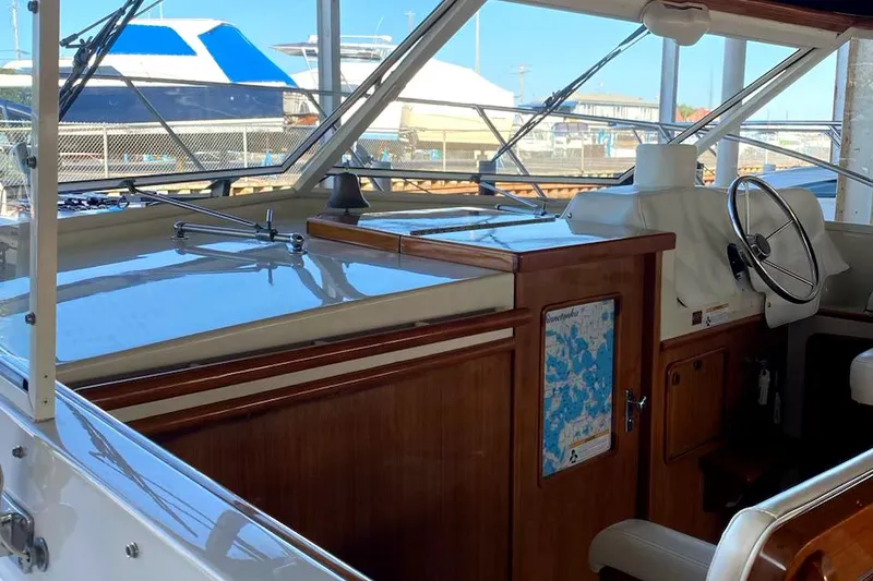 Slide: The Image of 1977 Chris-Craft 30 Sportsman boat interior with wooden dashboard and steering wheel. - 5