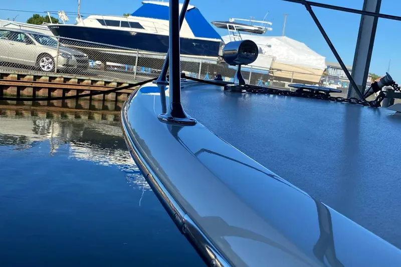 Slide: The Image of 1977 Chris-Craft 30 Sportsman boat docked, with a sleek, polished deck and marina background. - 6