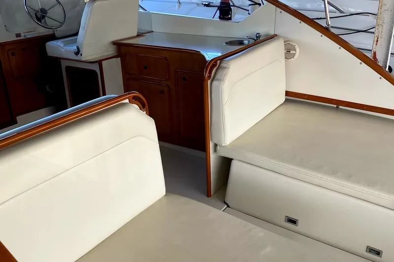 Slide: The Image of Interior of 1977 Chris-Craft 30 Sportsman boat with white seating and wooden accents. - 7