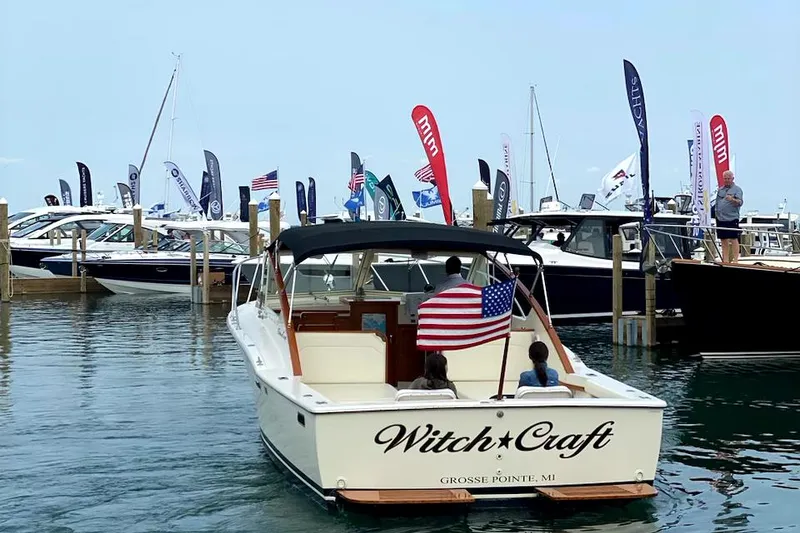 Slide: The Image of 1977 Chris-Craft 30 Sportsman boat named "Witch Craft" at a marina with flags. - 9