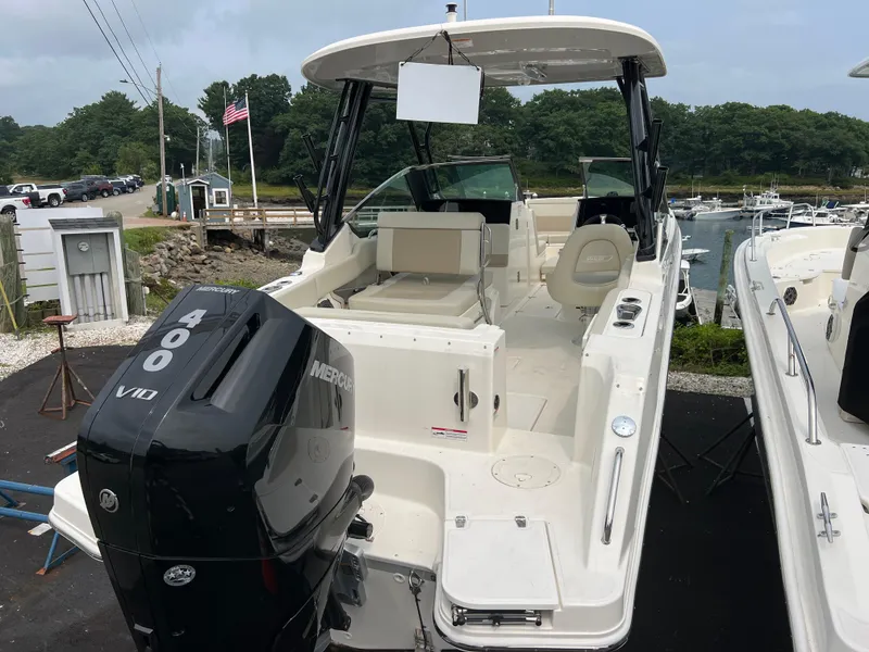 Slide: The Image of 2024 Boston Whaler 240 Vantage boat with Mercury 400 engine docked at marina. - 2