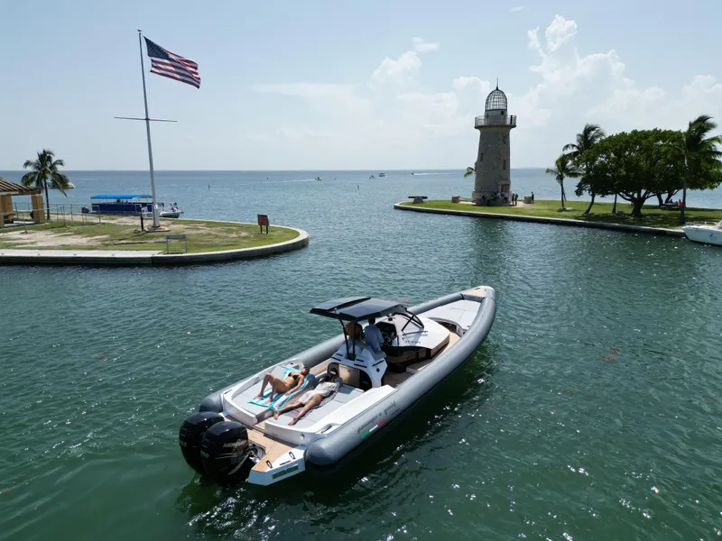 Slide: The Image of 2025 Panamera Yacht PY 100 cruising near a lighthouse and American flag. - 4