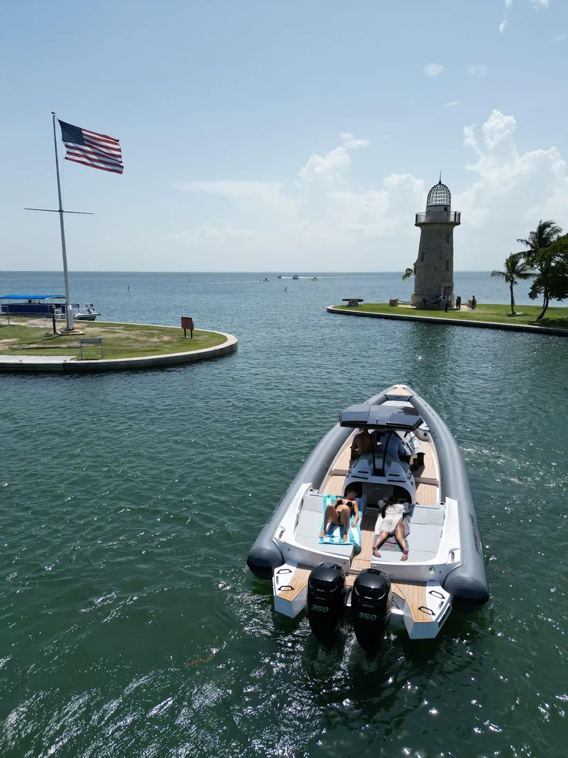 Slide: The Image of 2025 Panamera Yacht PY 100 cruising near a lighthouse and American flag. - 5
