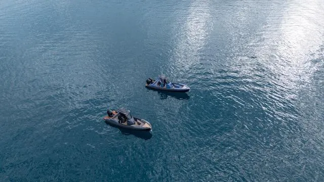 Slide: The Image of Two SuperRib Open 30 boats on calm blue water, 2025 model. - 22