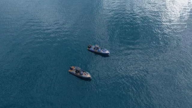 Slide: The Image of Two SuperRib Open 30 boats on calm blue water, 2025 model. - 23