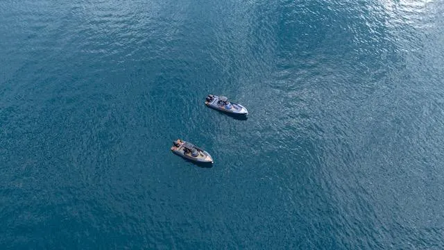 Slide: The Image of Two SuperRib Open 30 boats on calm blue water, 2025 model. - 24