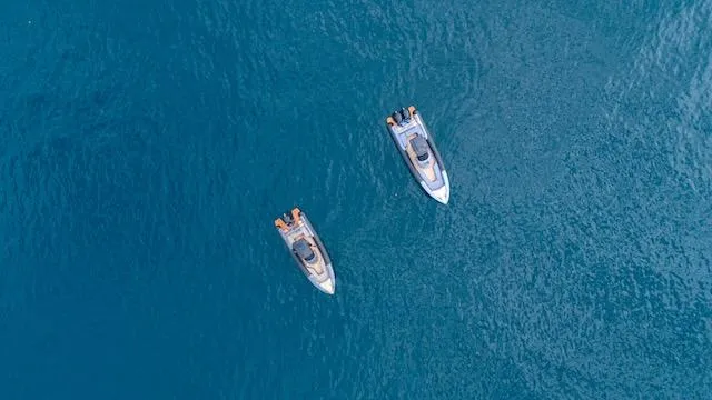 Slide: The Image of Two SuperRib Open 30 boats on clear blue water, aerial view, 2025 model. - 26