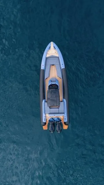 Slide: The Image of Aerial view of 2025 SuperRib Open 30 boat on calm blue water. - 29
