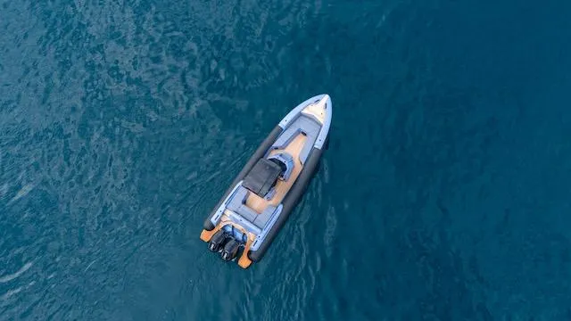 Slide: The Image of Aerial view of 2025 SuperRib Open 30 boat on blue water. - 31