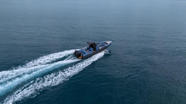 Slide: The Image of 2025 SuperRib Open 30 speeding on open water, creating a dynamic wake. - 36