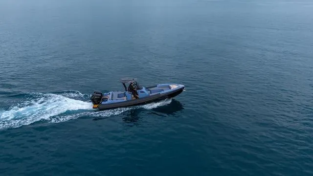 Slide: The Image of 2025 SuperRib Open 30 boat cruising on calm blue water. - 37