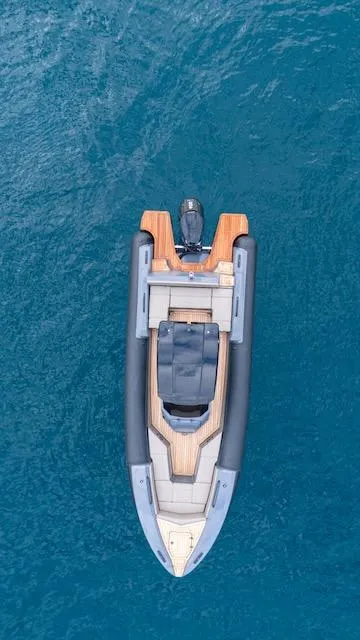 Slide: The Image of Aerial view of 2025 SuperRib Open 30 boat on blue water. - 38