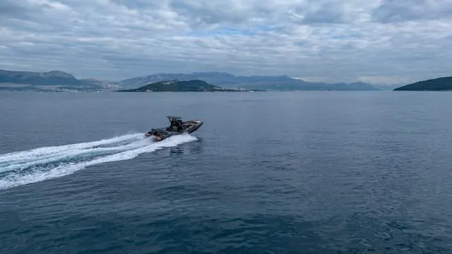 Slide: The Image of SuperRib Open 30 boat cruising on open water, 2025 model, under cloudy skies. - 39