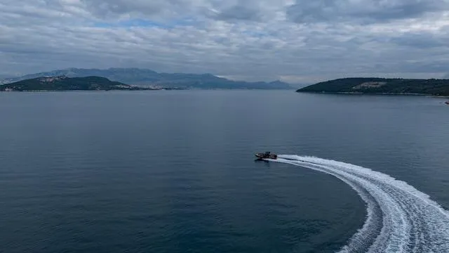 Slide: The Image of SuperRib Open 30 boat making a sharp turn on a calm sea, 2025 model. - 41