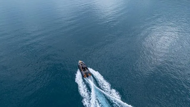 Slide: The Image of Aerial view of 2025 SuperRib Open 30 speedboat cruising on open water. - 42