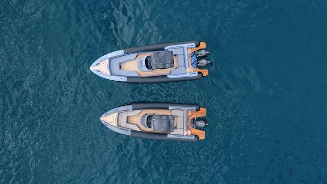 Slide: The Image of Two SuperRib Open 30 boats from 2025 on blue water, aerial view. - 43