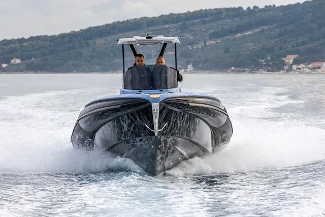 Slide: The Image of 2025 SuperRib Open 30 speedboat cruising on water, front view. - 45