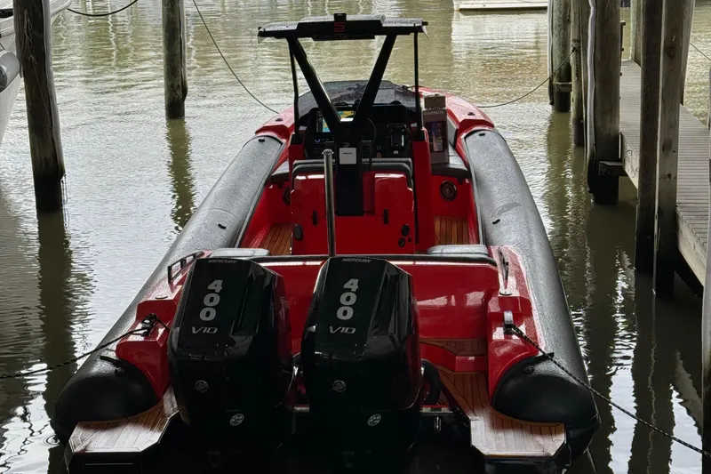 Slide: The Image of Red 2024 SuperRib Open 30 boat with twin 400 V10 engines docked. - 5