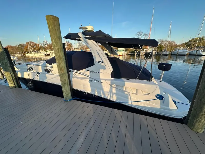 Slide: The Image of 2005 Sea Ray 340 Sundancer docked at marina with blue canvas cover. - 14