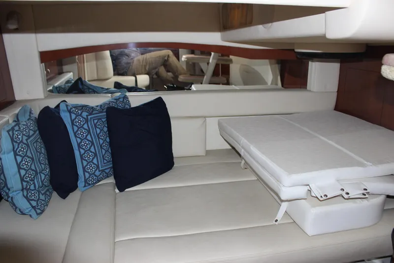 Slide: The Image of Interior cabin of 2005 Sea Ray 340 Sundancer with blue and white cushions. - 17