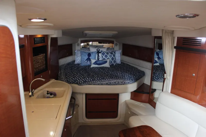 Slide: The Image of Interior cabin of a 2005 Sea Ray 340 Sundancer with bed, kitchenette, and seating area. - 20