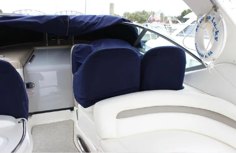 Slide: The Image of 2005 Sea Ray 340 Sundancer boat interior with blue seat covers and white upholstery. - 8