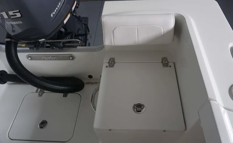 Slide: The Image of 2024 Parker 18 SE CC boat with Yamaha 115 engine, rear seating and storage compartments. - 12