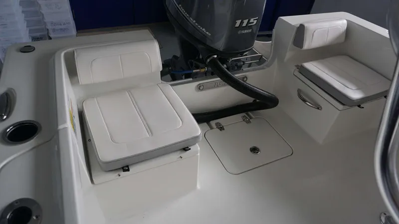 Slide: The Image of 2024 Parker 18 SE CC boat interior with Yamaha 115 outboard motor and cushioned seating. - 19