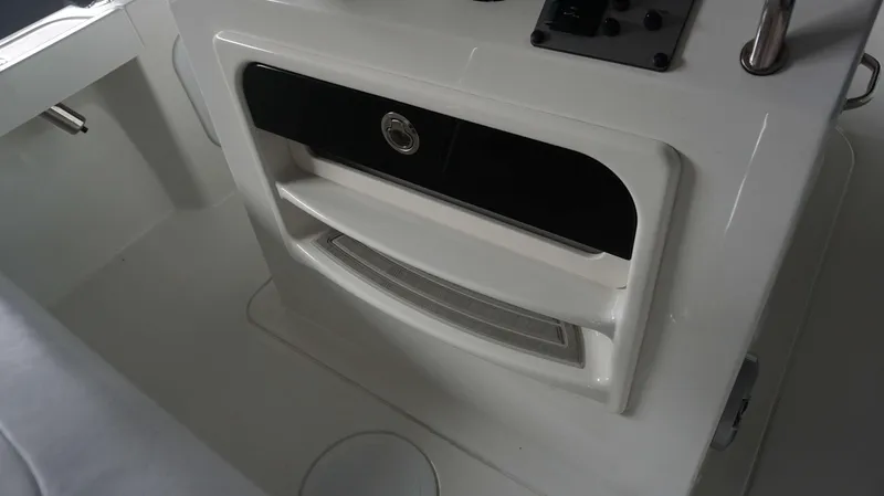 Slide: The Image of Console storage compartment on a 2024 Parker 18 SE CC boat. - 22