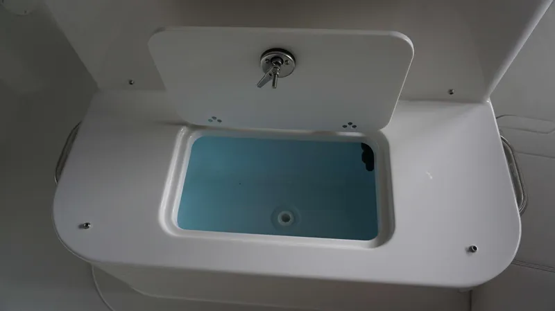 Slide: The Image of Livewell compartment of 2024 Parker 18 SE CC boat with open lid. - 3