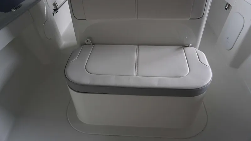 Slide: The Image of Parker 18 SE CC 2024 boat interior with cushioned seating. - 5