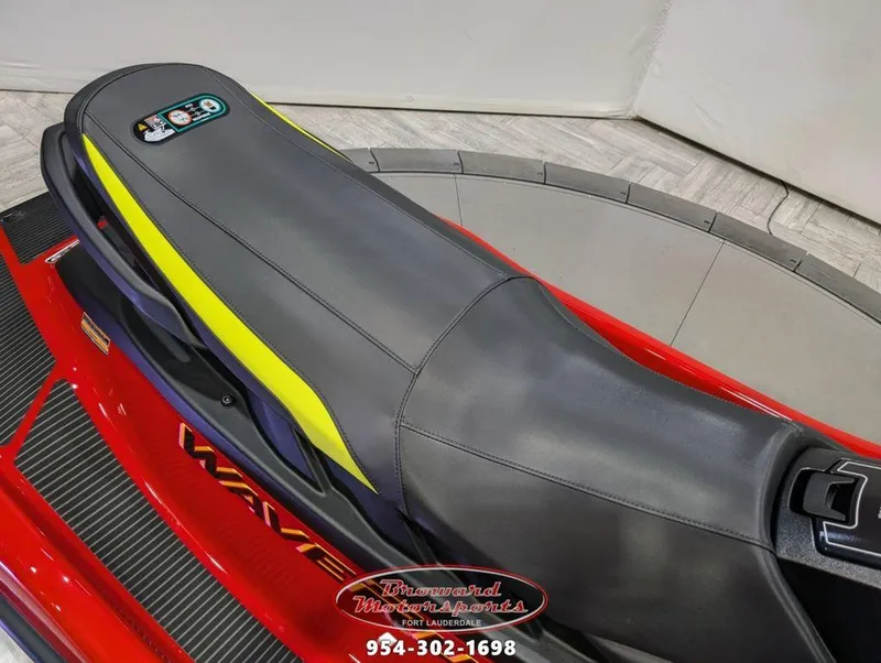 Slide: The Image of 2024 Yamaha EX® Deluxe jet ski seat, black and yellow design, Broward Motorsports logo. - 10
