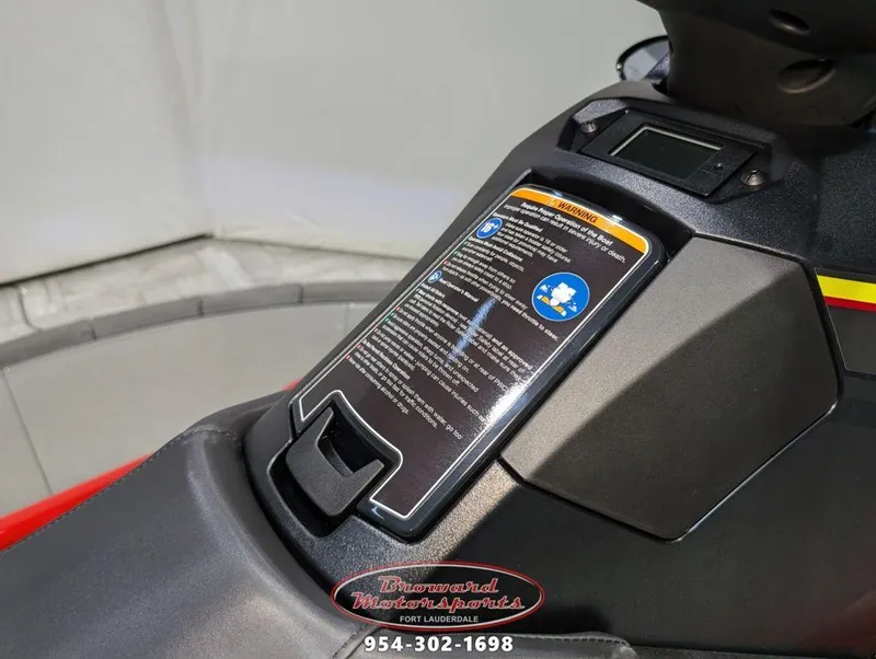 Slide: The Image of 2024 Yamaha Boats EX® Deluxe dashboard with warning label and controls. - 11