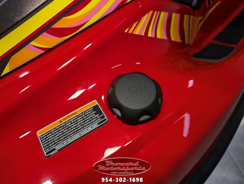 Slide: The Image of Close-up of 2024 Yamaha EX® Deluxe fuel cap with vibrant red and yellow design. - 16