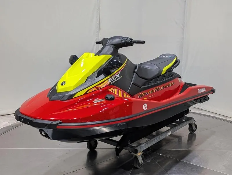 Slide: The Image of 2024 Yamaha EX® Deluxe WaveRunner in vibrant red and yellow on display. - 29