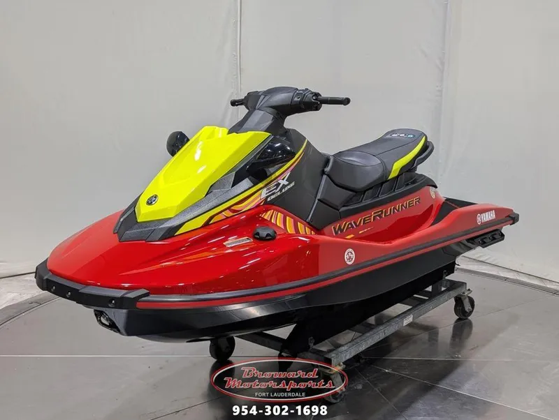 Slide: The Image of 2024 Yamaha EX® Deluxe WaveRunner in red and yellow on display stand. - 3