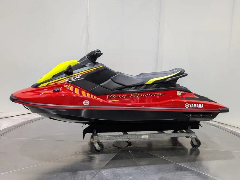 Slide: The Image of 2024 Yamaha Boats EX® Deluxe WaveRunner in vibrant red and yellow on display. - 30