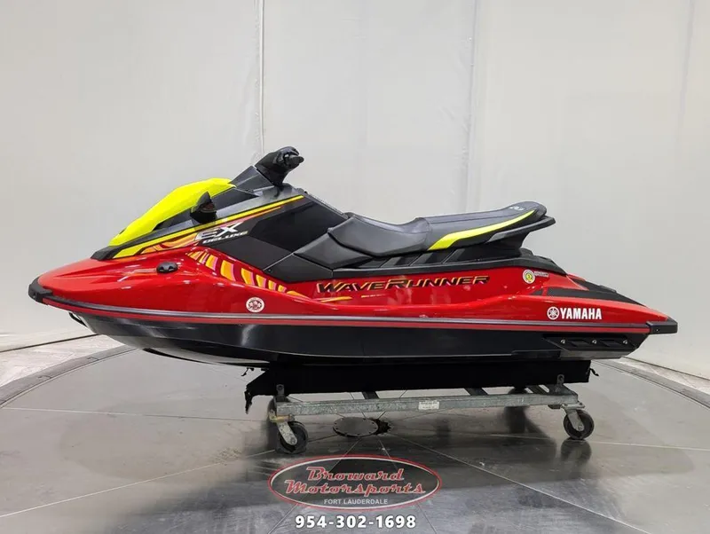 Slide: The Image of 2024 Yamaha EX® Deluxe WaveRunner, red and black, displayed on a showroom floor. - 4
