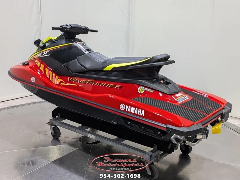 Slide: The Image of 2024 Yamaha EX® Deluxe WaveRunner in vibrant red and black, displayed indoors. - 5