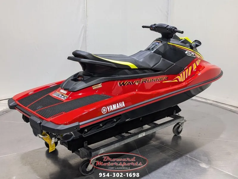 Slide: The Image of 2024 Yamaha EX® Deluxe WaveRunner in red and black on display stand. - 7