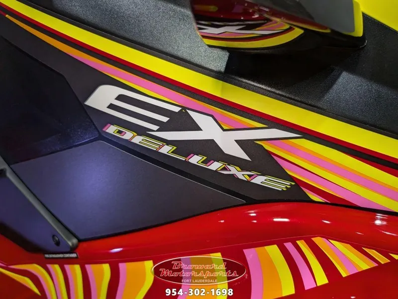Slide: The Image of 2024 Yamaha Boats EX® Deluxe with vibrant yellow and pink graphics. - 9
