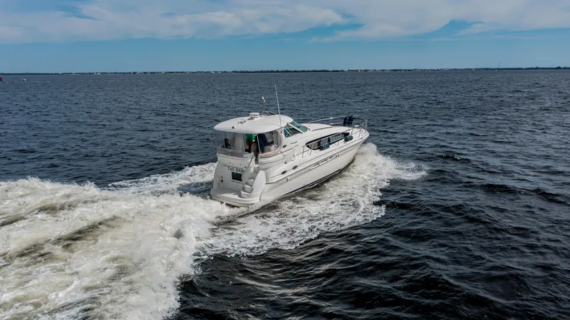 Slide: The Image of 2003 Sea Ray 390 Motor Yacht cruising on open water. - 1
