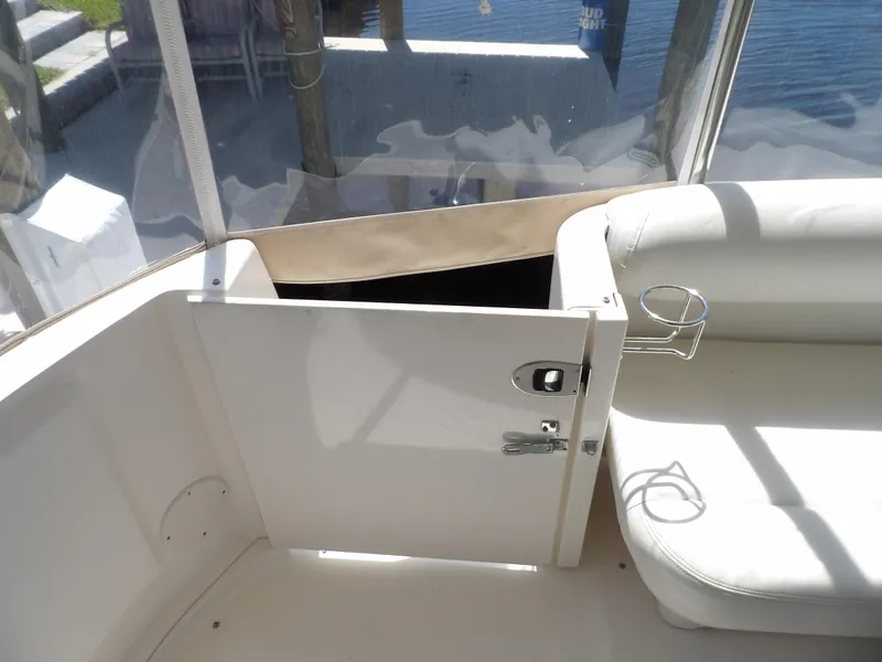 Slide: The Image of Sea Ray 390 Motor Yacht 2003 interior seating area with open door and cup holder. - 15